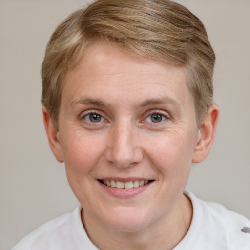 Joyful white young-adult female with short  brown hair and blue eyes