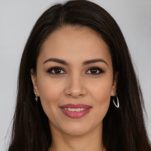 Joyful white young-adult female with long  brown hair and brown eyes