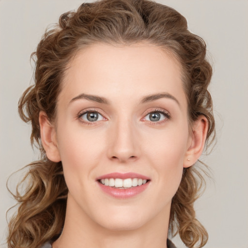 Joyful white young-adult female with medium  brown hair and green eyes