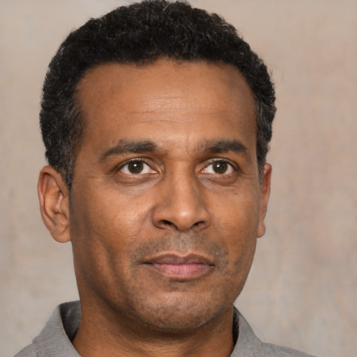 Neutral black adult male with short  black hair and brown eyes