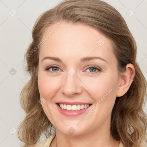 Joyful white young-adult female with long  brown hair and blue eyes