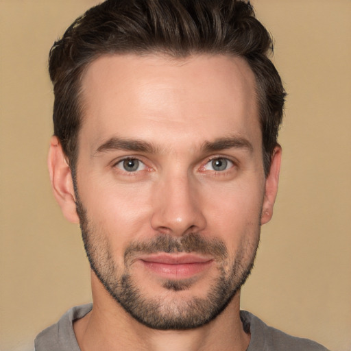 Joyful white young-adult male with short  brown hair and brown eyes