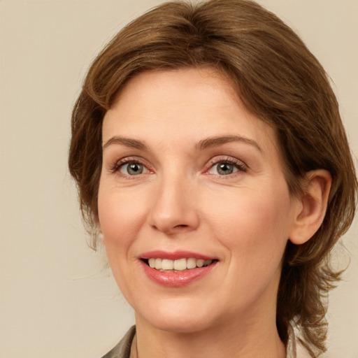 Joyful white young-adult female with medium  brown hair and grey eyes