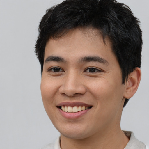 Joyful asian young-adult male with short  brown hair and brown eyes