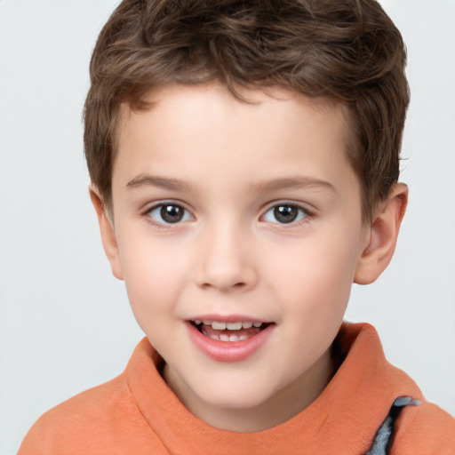 Joyful white child male with short  brown hair and brown eyes