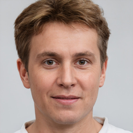 Joyful white adult male with short  brown hair and grey eyes