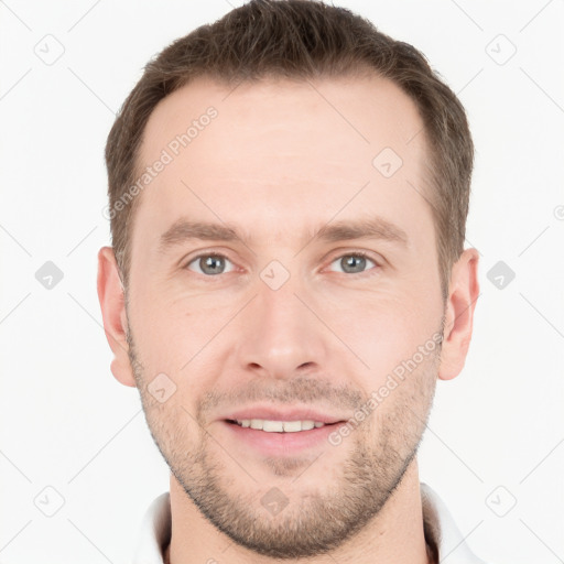 Joyful white young-adult male with short  brown hair and grey eyes