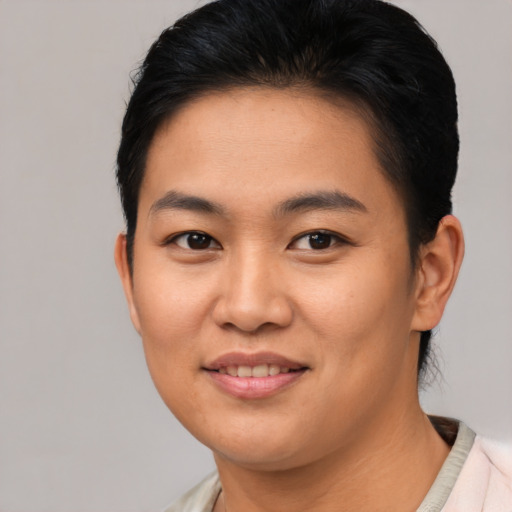 Joyful asian young-adult female with short  black hair and brown eyes
