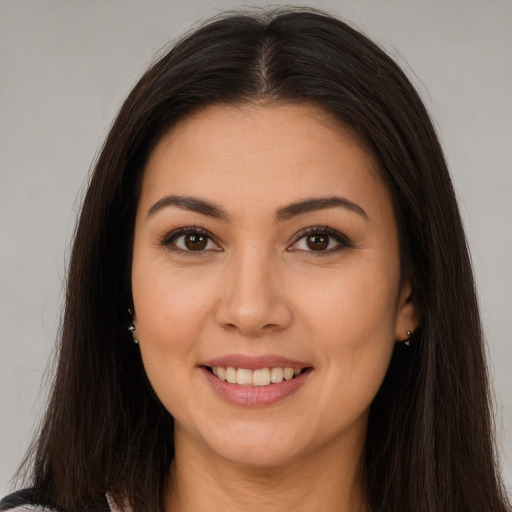 Joyful white young-adult female with long  brown hair and brown eyes