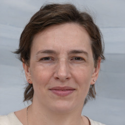 Joyful white adult female with medium  brown hair and brown eyes