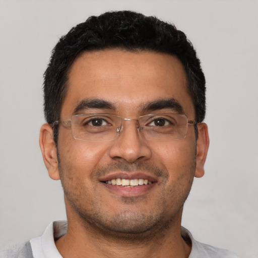 Joyful latino young-adult male with short  black hair and brown eyes