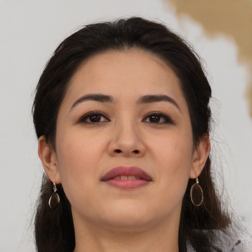 Joyful asian young-adult female with long  brown hair and brown eyes