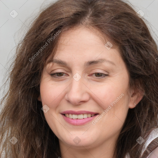 Joyful white adult female with long  brown hair and brown eyes