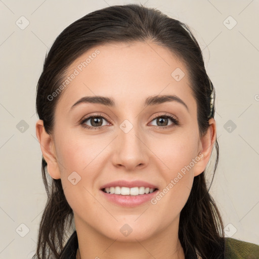 Joyful white young-adult female with long  brown hair and brown eyes