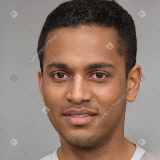 Joyful black young-adult male with short  brown hair and brown eyes