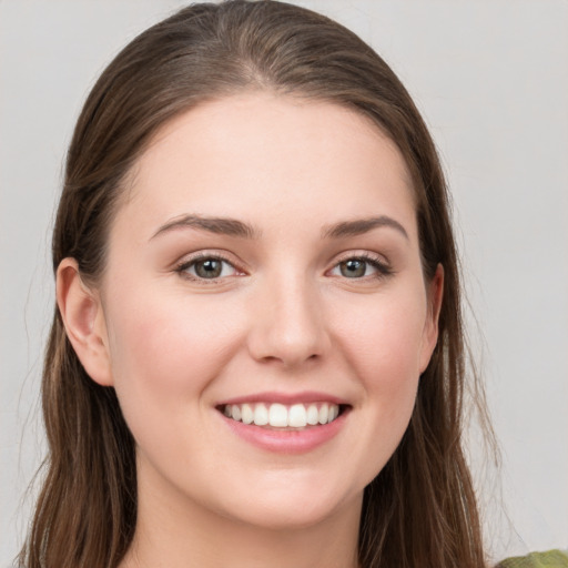 Joyful white young-adult female with long  brown hair and grey eyes