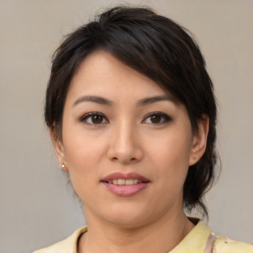 Joyful asian young-adult female with medium  brown hair and brown eyes