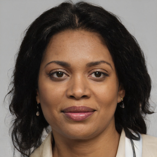 Joyful black young-adult female with medium  brown hair and brown eyes