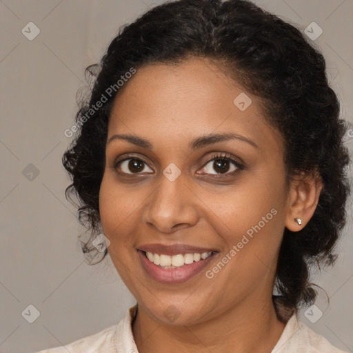 Joyful black young-adult female with medium  brown hair and brown eyes