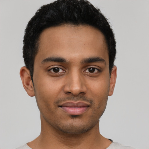 Joyful latino young-adult male with short  black hair and brown eyes