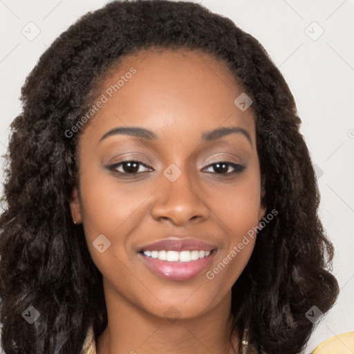 Joyful black young-adult female with long  brown hair and brown eyes