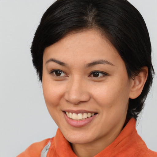 Joyful asian young-adult female with medium  brown hair and brown eyes