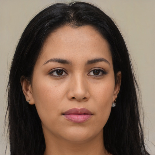 Joyful latino young-adult female with long  brown hair and brown eyes