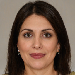 Joyful white adult female with medium  brown hair and brown eyes