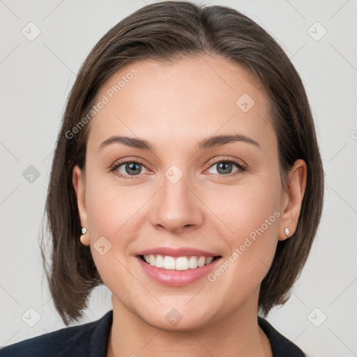 Joyful white young-adult female with medium  brown hair and grey eyes