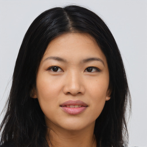 Joyful asian young-adult female with long  black hair and brown eyes