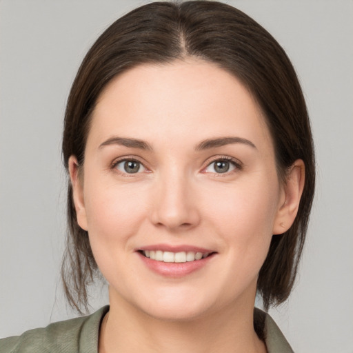 Joyful white young-adult female with medium  brown hair and brown eyes