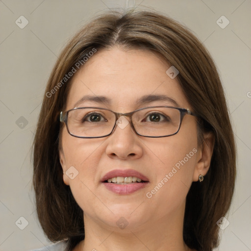 Joyful white adult female with medium  brown hair and green eyes