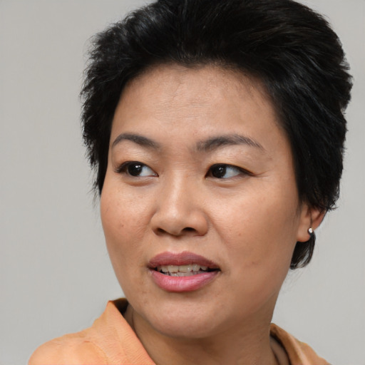Joyful asian adult female with short  brown hair and brown eyes