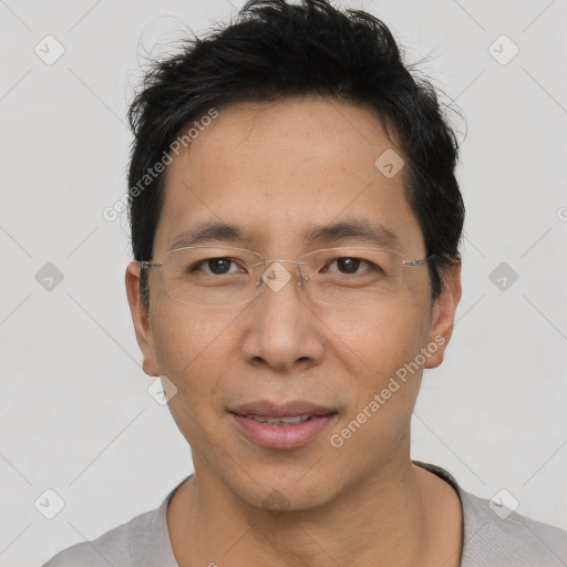 Joyful asian adult male with short  black hair and brown eyes