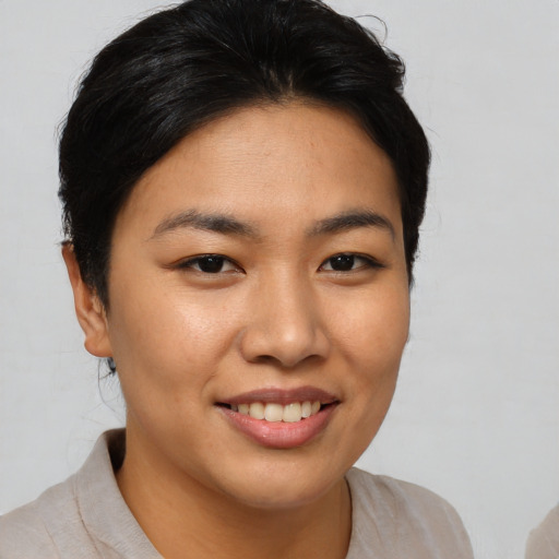 Joyful asian young-adult female with short  brown hair and brown eyes