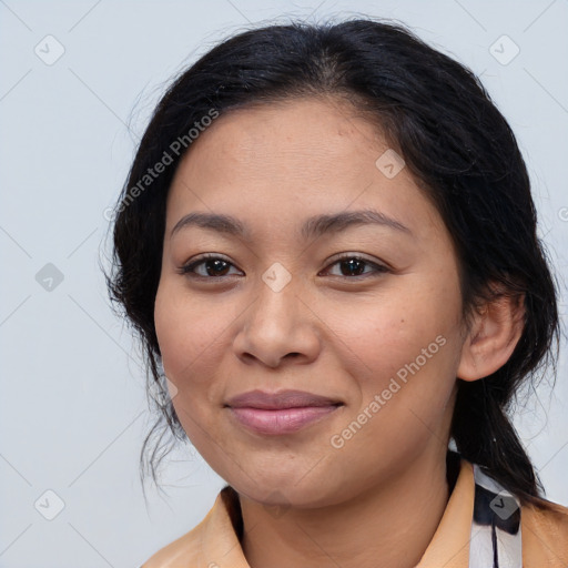 Joyful latino young-adult female with medium  brown hair and brown eyes