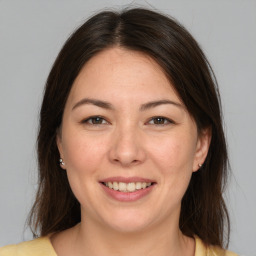 Joyful white adult female with medium  brown hair and brown eyes