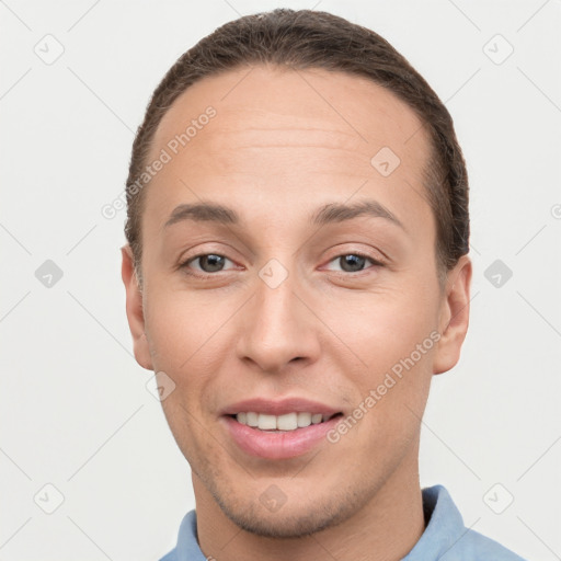 Joyful white young-adult male with short  brown hair and brown eyes