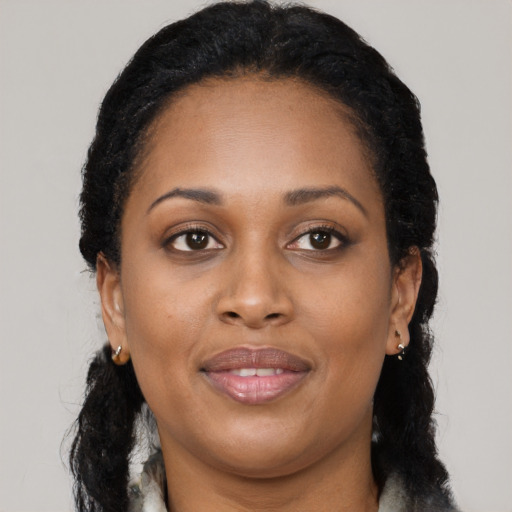 Joyful latino adult female with long  black hair and brown eyes