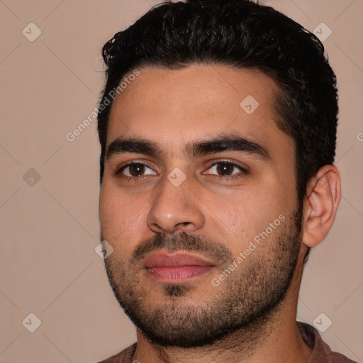 Joyful white young-adult male with short  black hair and brown eyes