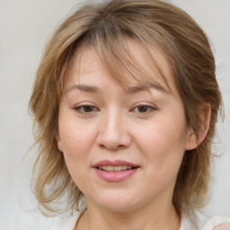 Joyful white adult female with medium  brown hair and blue eyes