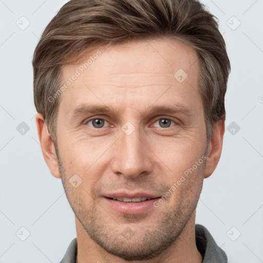 Joyful white adult male with short  brown hair and grey eyes