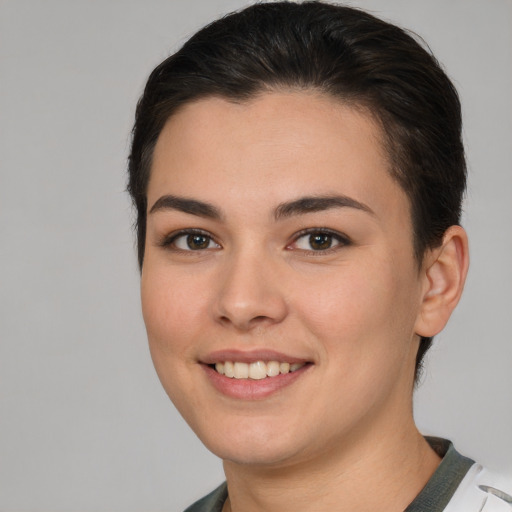 Joyful white young-adult female with short  brown hair and brown eyes