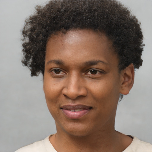 Joyful black young-adult female with short  brown hair and brown eyes