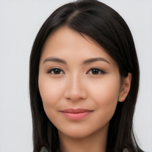 Joyful latino young-adult female with long  brown hair and brown eyes