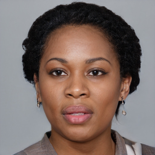 Joyful black young-adult female with medium  black hair and brown eyes