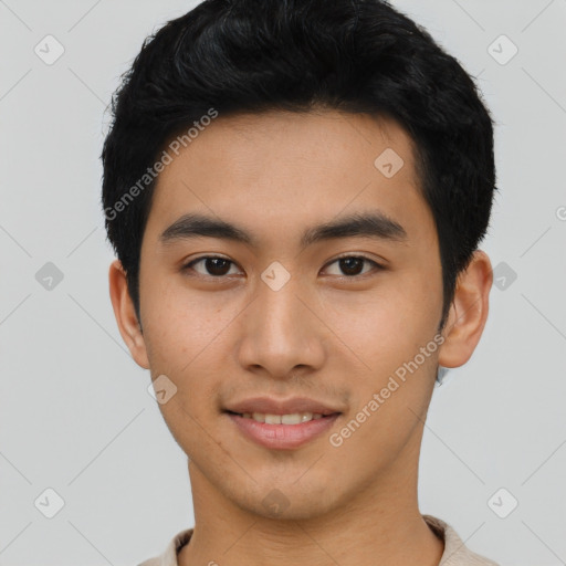 Joyful asian young-adult male with short  black hair and brown eyes