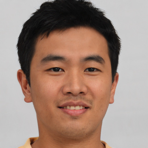 Joyful asian young-adult male with short  brown hair and brown eyes
