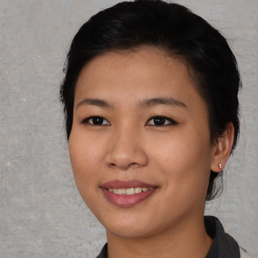 Joyful asian young-adult female with short  black hair and brown eyes