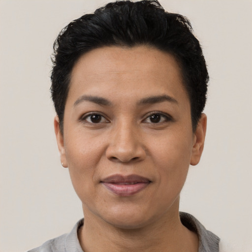 Joyful latino adult female with short  black hair and brown eyes